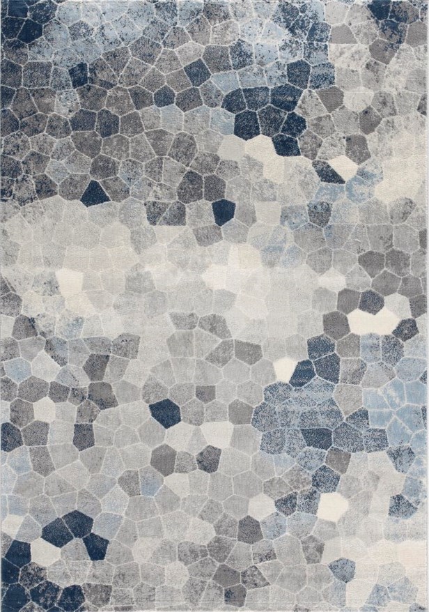 Picture of an area rug with an abstract geometric pattern of blues, greys, and beige